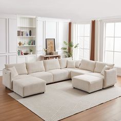 a living room with a large sectional couch and bookshelf on the wall behind it