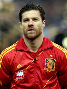 a close up of a soccer player wearing a red shirt