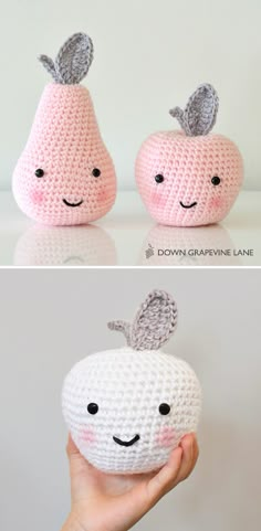 two crocheted apples with faces on them