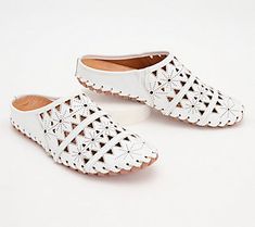 A geometric cutout design gives these leather mules a light and airy feel with breathable comfort for your feet. From Spring Step. Spring Flat Heel Slip-ons With Perforations, Modern Spring Slip-ons With Leather Footbed, White Flat Heel Clogs For Spring, Modern Leather Footbed Slip-ons For Spring, White Spring Clogs With Flat Heel, Spring Leather Footbed Slip-on Clogs, Slip-on Perforated Sandals For Spring, White Slip-ons With Perforated Toe Box, Modern Leather Sole Slip-ons For Summer