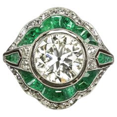 This vintage style diamond ring is gorgeously designed and handcrafted with a dazzling 1.89 carat old cut diamond center and spring green calibre cut emerald accents! Highlights: - 1.89ct EGL-USA certified center diamond - Large spread and a look comparable to a typical 2 carat - Beautiful old transitional cut - Excellent VS2 clarity - Very minimal warmth with J-K color. Faces up nicely white in contrast to the emeralds - Natural emerald accents with bright and vibrant color - Bright white and v European Cut Diamond Ring, Edwardian Jewelry, Unusual Jewelry, First Art, Italian Art, Art Deco Era, European Cut Diamonds, Platinum Ring, Emerald Jewelry