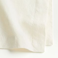 two white linen sheets folded on top of each other