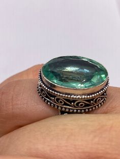 Large brilliant emerald green antique glass  Ornate German Silver  NOT 925  Vintage ring, does not tarnish Size 7.5 can be re sized, my jeweler charges a $20 fee All rings are shipped free in the US in a nice gift box.   Check out our over a THOUSAND great reviews Engraving is $4 per letter and is not always perfect depending on the piece. It can take a few days if the jeweler is busy. This is payable to Paypal Judithsltd@gmail.com Green Sterling Silver Topaz Ring, Green Oval Topaz Ring In Sterling Silver, Unique Stamped 925 Oval Emerald Ring, Unique Oval Emerald Ring Stamped 925, Vintage Green Crystal Ring For Anniversary, Green Oval Crystal Ring In Sterling Silver, Oval Green Crystal Sterling Silver Ring, Silver Oval Crystal Ring For May Birthstone, Bohemian Green Crystal Round Ring