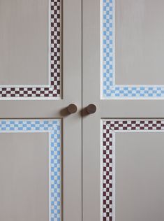 two doors with checkered designs painted on them