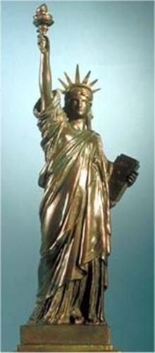 the statue of liberty is gold and has a torch in it's left hand