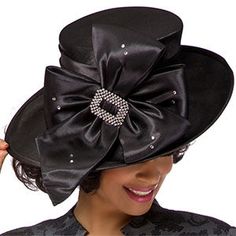 Introducing the exquisite Giovanna HG1103-BLK Church Hat, a stylish accessory designed to add an air of elegance and sophistication to your special occasion wear. This beautiful hat is crafted with careful attention to detail, ensuring that you look nothing short of stunning when attending any event requiring a touch of class. The hat is presented in a classic black color, imbued with a lustrous sheen that radiates style. Its design features a prominent bow, artfully crafted to draw the eye and Chic Hats With Bow And Curved Brim, Elegant Winter Party Top Hat, Evening Hats With Bow And Short Brim, Kentucky Derby Party Hat With Satin Bow, Kentucky Derby Evening Hat With Satin Bow, Elegant Adjustable Black Cloche Hat, Elegant Hat With Satin Bow For Party, Winter Party Hats With Bow, Elegant Party Hat With Satin Bow