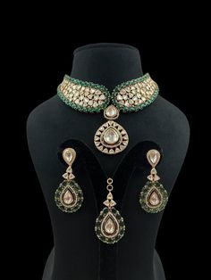 Green Polki Choker emerald Kundan centerpiece surrounded by radiant Kundan Polki stones, crafted in gold with intricate Jadau detailing. Inspired by Sabyasachi, it boasts the brilliance of Moissanite and uncut diamonds, offering a statement of opulent elegance perfect for a grand Indian wedding. *𝐏𝐑𝐎𝐃𝐔𝐂𝐓 𝐃𝐄𝐓𝐀𝐈𝐋* * Material: Brass * Plating: Gold Plated * Stone: Semi Precious Kundan, Polki & Green Stone. *𝐃𝐈𝐒𝐂𝐋𝐀𝐈𝐌𝐄𝐑* Product color may slightly vary due to photographic light Traditional Gold Emerald Necklace With Diamonds, Gold Emerald Necklace For Reception, Festive Kundan Emerald Necklace For Receptions, Dazzling Kundan Jewelry For Reception, Festive Dazzling Kundan Jewelry, Traditional Round Emerald Necklace For Wedding, Festive Hand-set Emerald Necklace For Wedding, Traditional Hand Set Emerald Necklace For Reception, Dazzling Hand Set Gold Emerald Necklace