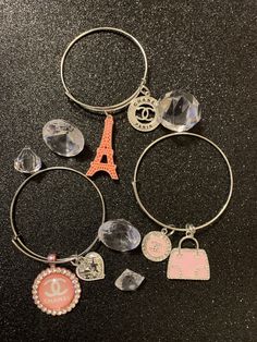 Paris Me Please Charm Bracelets shown here are made with different shades of pink Trendy Charms Bracelets For Friendship, Pink Metal Bracelets For Gifts, Pink Metal Jewelry, Handmade Pink Metal Bracelets, Trendy Assorted Bracelets For Friendship, Handmade Pink Metal Bracelet, Pink Metal Jewelry Fashion Accessory, Pink Metal Jewelry As Fashion Accessory, Pink Bangle Jewelry