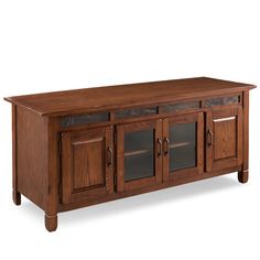 a large wooden entertainment center with glass doors and drawers on one side, in an oak finish