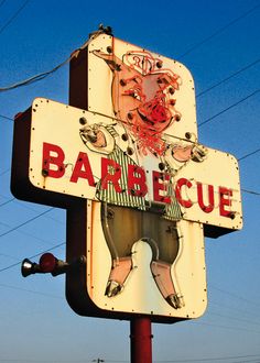 a sign for a barbeque restaurant with a pig on it's back