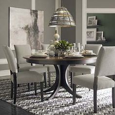 a dinning room table with chairs around it and a rug on the floor next to it