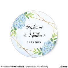 a round wedding sticker with blue flowers and gold geometric lines on the bottom, in white