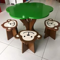 children's table and stools made to look like monkeys under a green tree