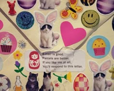 there are many stickers on the back of a mailbox that is decorated with cats and bunny ears