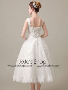 a woman in a white wedding dress looking back