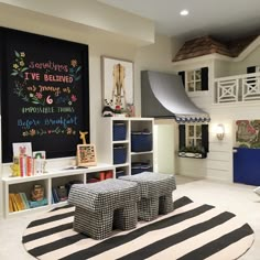 a child's playroom with black and white striped rugs, chalkboard on the wall