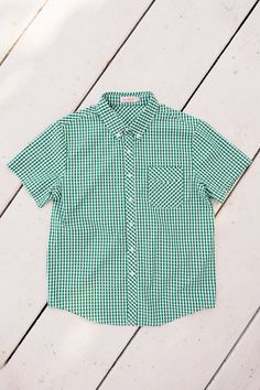 Unleash your vibrant style with the Mens James Shirt in Green Gingham! Featuring a classic button up design with a sharp collar and short sleeves, this shirt will keep you looking sharp and stylish. The white and green gingham print adds a touch of sophistication, while the front pocket provides functional convenience. Don't forget the matching styles for the whole family. Classic Green Collared Short Sleeve Shirt, Classic Plaid Shirt For Summer, Green Collared Short Sleeve Shirt For Summer, Classic Plaid Short Sleeve Shirt For Summer, Classic Green Short Sleeve Shirt, Plaid Short Sleeve Summer Shirt, Green Cotton Short Sleeve Shirt With Spread Collar, Spring Gingham Shirt With Spread Collar, Green Cotton Short Sleeve Shirt For Spring