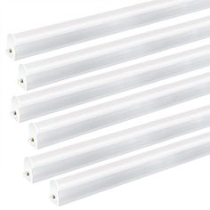 four white fluorescent tubes are lined up against each other on a white background with clippings