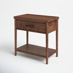 a small wooden table with one drawer on the top and two shelves below it, against a white background