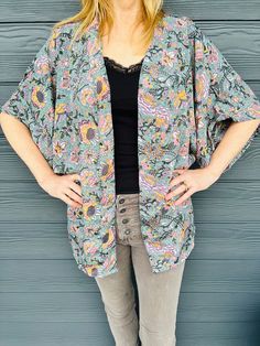 "Bohemian kimono cardigan top / Long sleeve Silk kimono / Kimono style blouse / Pink and grey kimono jacket / Christmas gift for her Our Boho style vintage silk kimono  makes a unique Christmas gift for her.  Our designs are handmade in small batches and are one of a kind.  Layer up for Winter, looks great with denims or use as a beach wrap in Summer. Made from vintage silk blend fabric. Freesize fits UK XS to L Length  27\"/69cm Sleeve Length 16\"/41cm Sleeve circumference 26\"/33cm Body circumference 45\"/116cm 3/4 length wide sleeve Open closure. Hand wash in cold water. Each package we send is gift wrapped in a unique recycled reusable printed bag Shipping Times:  Your items will be sent within 1 to 2 working days. Free Shipping to the UK. Follow us on Instagram @anandawild__ or on Fac Spring Bohemian Short Sleeve Cardigan, Bohemian Short Sleeve Spring Outerwear, Casual Floral Print Cardigan With Kimono Sleeves, Casual Cardigan With Floral Print And Kimono Sleeves, Casual V-neck Patterned Kimono, Spring Loungewear Tops With Kimono Sleeves, One Size Open Front Floral Print Cardigan, Bohemian Short Sleeve Outerwear For Fall, Bohemian Open Front Printed Tops