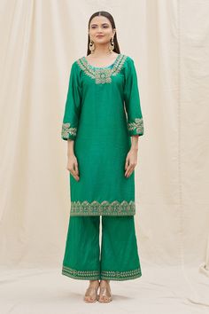 Green kurta with embroidered neckline and cuffs crafted in silk. Comes with flared pant and contrast dupatta.
Components: 3
Pattern: Embroidery
Type Of Work: Sequins, Zari, Thread work
Neckline: Scoop
Sleeve Type: Three quarter
Fabric: Kurta and Pant: Silk, Dupatta: Organza
Color: Green,Peach
Other Details: 
Floral embroidery
Dusty peach dupatta
Occasion: Mehendi and Haldi - Aza Fashions Eid Long Sleeve Sets With Embroidered Neckline, Eid Sets With Embroidered Neckline And Long Sleeves, Long Sleeve Sets With Embroidered Neckline For Eid, Eid Festival Fitted Set With Embroidered Neckline, Traditional Long Sleeve Set With Embroidered Neckline, Fitted Sets With Embroidered Neckline For Eid, Anarkali Set With Embroidered Neckline For Eid, Traditional Sets With Embroidered Neckline For Diwali, Traditional Set With Embroidered Neckline For Diwali