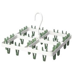 a white rack with green cactus plants and an umbrella on the top, in front of a white background