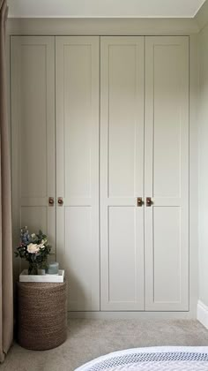 a bedroom with white closets and carpeted flooring