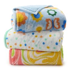 three baby blankets stacked on top of each other