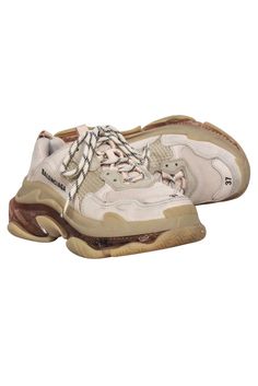 Fashionistas, feast your eyes on Balenciaga's Triple S sneakers--the ultimate street style accessory! Bicolored laces, triple stacked soles, and color blocked neutrals make these chunky fly-kicks a must-have for looking and feeling your best. Style these trendy sneakers with raw hem jeans and a neutral crop top. Size 7 (37) Double foam and mesh Leather free Bicolor laces Embroidered logo on side Embossed logo on back Triple S rubber branding on the tongue Oblong heel platform Discoloration on toes Sporty Beige Platform Sneakers, Sporty Beige Platform Sneakers With Laces, Chunky Lace-up Sneakers With Textured Sole, Trendy Beige Sneakers With Rubber Sole, Lace-up Chunky Sneakers For Streetwear, Beige Platform Sneakers Lace-up, Beige Platform Sneakers With Lace-up Detail, Beige Low-top Chunky Sneakers With Laces, Beige High-top Chunky Sneakers With Laces