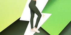 a woman in black leggings is standing on a green and white striped wall