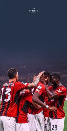 a group of men standing next to each other on a soccer field