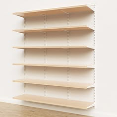 an empty shelf in the corner of a room