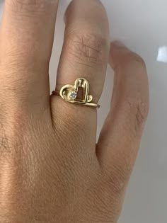 14kt yellow gold ring set with a .025ct diamond! Weighs 1.6dwt and is currently a size 5 but can be resized! Gold Diamond Ring Stamped 14k For Valentine's Day, Yellow Gold Solitaire Heart Ring For Promise, Yellow Gold Heart Ring With Prong Setting For Promise, Gold Heart Ring With Prong Setting For Promise, Gold Heart Shaped Solitaire Rings, Valentine's Day Gold Ring With Diamond Accents, 14k Gold Heart Ring With Prong Setting For Promise, 14k Gold Heart Ring With Single Diamond For Promise, Gold Heart Ring With Single Diamond In 14k Gold