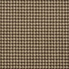 a brown and white checkered fabric with small black dots on the bottom half of it