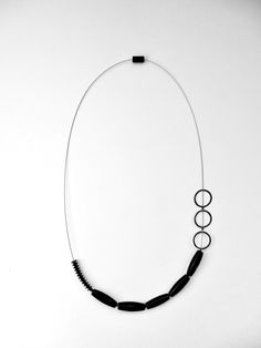 Silver Necklace - A study of balance and asymmetry, this unique necklace arranges blackstone beads, sterling silver elements, and rubber on a stainless steel cable. Modern Black Onyx Necklace, Modern Onyx Jewelry With Black Beads, Modern Black Jewelry, Everyday Black Single Strand Necklace, Contemporary Adjustable Black Jewelry, Modern Black Sterling Silver Necklace, Stainless Steel Cable, Artful Home, Stylish Necklace