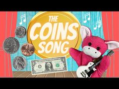 a pink stuffed animal holding a guitar next to money and coins on a wooden table