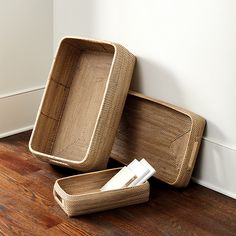 two wicker baskets sitting on the floor next to each other with napkins in them