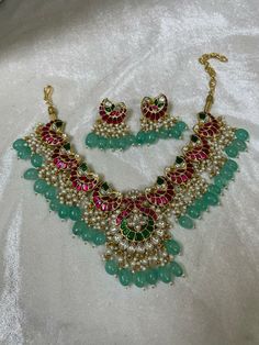 Indian Ethnic Jadau Ahemdabadi Kundan 22 Carat Gold Plated Sea Green Necklace Set * This Set Is made up with High Quality Pachi Kundan * 22 Carat Gold Plating Is used * High Quality Beads Are used * Set includes Necklace,Earrings  * Droppings color can be changed according to your requirement We made Jewelry in pachi kundan /Ahemdabadi kundan and made designs on order only , need atleast 25 days to make ,to do customization as they are acceptable. jewellery details :All jewellery are made with silver base and luxury gold plated next to real,generally we work on direct made on order.   We are  the dealers of Authentic and traditional Indian Jewelry  We  are honored to present you our elegant, stylish and unique designs with a  wide range of items in different Indian Jewelry category. Here i Traditional Indian Jewellery, Kundan Jewelry, Necklace Indian, 22 Carat Gold, Indian Necklace, Indian Jewelry Sets, Fashion Jewelry Sets, Handcrafted Necklace, Kundan Jewellery