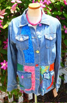 Joseph had his coat of many colors, and now you can too! This ladies large denim safari style jacket is accented with a rainbow of batik fabrics and buttons to highlight its design. You will turn heads while wearing this one-of-a-kind jacket to the football game, parties, school or work. This needs to be in your basket right now. FREE SHIPPING Multicolor Denim Jacket With Pockets For Spring, Spring Multicolor Outerwear With Patch Pockets, Multicolor Denim Jacket With Patches For Spring, Multicolor Patched Denim Jacket For Spring, Multicolor Denim Jacket With Pockets For Fall, Bohemian Cotton Outerwear With Button Closure, Colorful Bohemian Outerwear For Spring, Hippie Style Outerwear With Pockets For Fall, Hippie Cotton Outerwear With Pockets