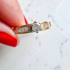 Princess cut & Baguettes Vintage Engagement Ring 14K Yellow Gold Center stone Round Diamond 0.25Ct I Color IS1 Baguette Diamond side stones 0.30Ct J/I Color SI1/SI2 3.4gm Size 7.25 Sizing available with fee contact us to have it added to the price before check out. Thank you for visiting our shop! Visit our website DmKJewelry.com Also Follow us on Instagram https://www.instagram.com/dmkjewelry_/ Emerald Cut Baguette Diamond Promise Ring, Yellow Gold Cluster Ring With Brilliant And Baguette Cut, Yellow Gold Cluster Ring With Baguette And Brilliant Cut, Promise Ring With Baguette Diamonds, Channel Set Baguette Rings For Anniversary, Baguette Channel Set Rings For Anniversary, Dazzling Round Cut Diamond Ring With Baguette Diamonds, Yellow Gold Cluster Ring With Baguette Cut Cubic Zirconia, Dazzling Round Cut Baguette Diamond Ring