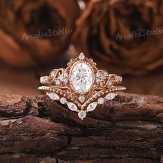 a close up of a ring on a piece of wood with roses in the background