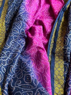 This is beautiful vintage Sari fabric that is a mix of navy & fuchsia with a  gold thread embroidered border!   There are 5 3/4 yards of fabric @  44" wide, bought at the traditional Pushkar Fair in northern India.   The switchback pattern throughout is whimsical in its classic "squiggle" mixed with a paisley!   You can see there are changes to the colors as a result of the hand dying process.   The fuchsia virtually "bleeds" into the navy beautifully but there are also color changes right within one color, as in the fuchsia.   If you were to wear as a traditional sari, it would fall in a beautiful mixed pattern coloration but if you are planning on using it on a flat surface, molded pillow or a custom made dress, you will have enough yardage to work around any of the variations! Pushkar Fair, Custom Made Dress, Made Dress, Embroidered Border, Vintage Sari, Sari Fabric, Silk Sari, Vintage Saris, Gold Thread