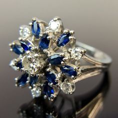 Metal:14k White Gold Weight:6.2 Grams Size:6.25 CTW:1.2 - 1.49 Carats 1 3.5mm round diamond 6 2.25mm round diamonds 12 3.5mm by 2mm marquise-cut sapphires, approx. 0.88 - 1.08 carats Make an offer! Marquise Multi-stone Diamond Ring, Classic Multi-stone Sapphire Ring With Diamonds, Diamond White Marquise Multi-stone Ring, Classic Multi-stone Diamond Rings, Diamond White Multi-stone Marquise Rings, White Gold Marquise Multi-stone Diamond Ring, Diamond White Marquise Multi-stone Jewelry, White Sapphire Multi-stone Diamond Ring, Dazzling Multi-stone Diamond Jewelry