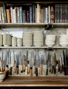 the shelves are filled with many different types of kitchen utensils