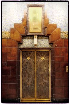 an ornate door to a building with tiled walls