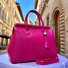 This bag has been made of the best genuine leather by local master crafters of Florence in Italy, designed for women who only accept premium Italian quality and luxury leather bags and modern Italian fashion. . Size: Height: 28 cm/11.02 inches. Width: 33 cm/12.99 inches. Depth: 15 cm/ 5.91 inches. Color: Fuchsia . The story of this bag:  In the heart of Italy, where artistry and craftsmanship have flourished for centuries, a group of skilled artisans pours their passion into creating exquisite l Elegant Pink Satchel As A Gift, Elegant Pink Satchel As Gift, Classic Pink Leather Bag, Elegant Pink Satchel Gift, Pink Leather Bags For Everyday Luxury, Elegant Satchel With Leather Lining As Gift, Elegant Satchel With Leather Lining For Gift, Pink Leather Bag For Formal Occasions, Pink Rectangular Shoulder Bag For Everyday Luxury