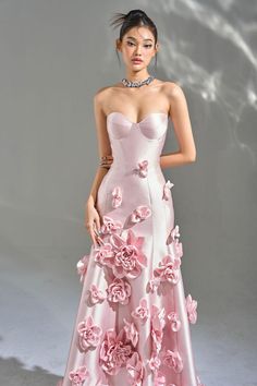 Indulge in a sense of exquisite luxury as you slip into the Samara 3D Floral Strapless Maxi Dress. Handmade from opulent taffeta satin, this breathtaking dress boasts a sweetheart neckline, intricate floral appliques, and an elegant asymmetrical silhouette. Complete with a lace-up back, it is the perfect choice for any formal event or special occasion. Handmade-To-Order. Satin. Unlined. Runs true to size. Hand Wash Cold. Do Not Bleach. Line Dry. Iron Low Heat. ** This dress is Made-To-Order. Whether you choose a standard size or custom measurements, each dress is uniquely handmade by our master tailors to order. Product color may vary due to lighting on images and screen resolution. * For Custom Size - Once you successfully placed an order, please reply to the order confirmation email with Pink Flower Gown, Fancy Stage Outfits, Pink Gown Princesses, Luxury Dress Aesthetic, Formal Spring Dresses, High Fashion Prom Dresses, Fairytale Dress Princesses Ball Gowns, Prom Dresses With Flowers, Mommy Photoshoot