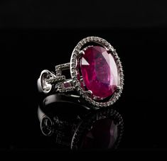 Diamond Pink Ruby Ring, 14K White Gold Oval (6.16ct) Ruby. This gorgeous vintage estate ring is finely crafted in solid 14K White gold and set with natural Earth mined Pink Ruby and genuine diamonds.  The center oval cut gem measures 14mm x 11mm (6.16 carats).  This is a very good quality stone with great intensity and strong brilliance.  The center stone is surrounded by 44 diamonds plus 26 diamonds on the sides. These diamonds are SI clarity and H color totaling (.70cttw) The top of the ring measures 19mm x 16mm.  Size 6.5 (can be sized).  The ring weighs 8.4 grams.  Great estate condition. * * * * * * * * PLEASE, READ DESCRIPTIONS CAREFULLY. Choose ACCORDINGLY. We want you to be completely satisfied with your purchase. If for any reason you are not entirely pleased, simply return the it Luxury Oval Ruby Ring, Luxury Oval Ruby Ring With Center Stone, Luxury Ruby Ring With Oval Center Stone, Luxury Oval Ruby Ring With Prong Setting, Luxury Oval Ruby Ring For Formal Occasions, Luxury Oval Ruby Ring With Gemstone, Elegant Gia Certified Oval Ruby Ring, Elegant Oval Ruby Ring With Vvs Clarity, Ruby Ring Vintage