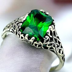 Unlock the timeless elegance of our Vintage Emerald CZ Solitaire Ring, a stunning piece crafted from 925 solid sterling silver. Adorned with exquisite filigree detailing, this ring is not just a piece of jewelry; it's a heartfelt expression of love, perfect for birthdays or anniversaries. The striking emerald-inspired gemstone, the birthstone of May, captures the eye and elevates any outfit. Surprise someone special or treat yourself to a symbol of enduring beauty and elegance. Embrace your unique style--add this enchanting ring to your collection today! Excellent Condition, Satisfaction Guaranteed! May Birthstone Elegant Silver Crystal Ring For May Birthstone, Green Engraved Jewelry For Anniversary, Emerald Jewelry With Intricate Design For Gift, Elegant Silver May Birthstone Ring, Formal Silver Crystal Ring With Birthstone, Green Emerald Ring With Intricate Design For Gift, Filigree Ring For May Birthstone Gift, Emerald Rings With Intricate Design For Anniversary, May Birthstone Filigree Ring Gift