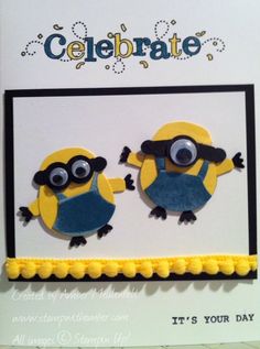 a card with two yellow and blue minion magnets on it's side